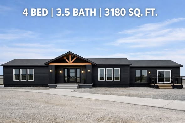 Modern dark gray, single-story house with four large windows and a porch. The sky is clear. Text reads: "4 Bed | 3.5 Bath | 3180 sq. ft."