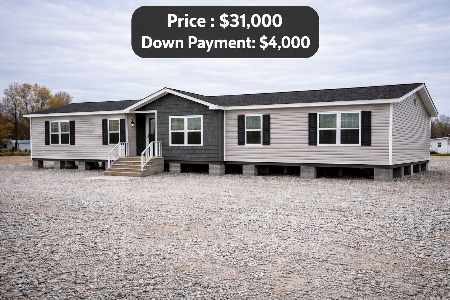 Single-story beige manufactured home with black shutters on a gravel lot, overcast sky. Text overlay: "Price: $31,000, Down Payment: $4,000."