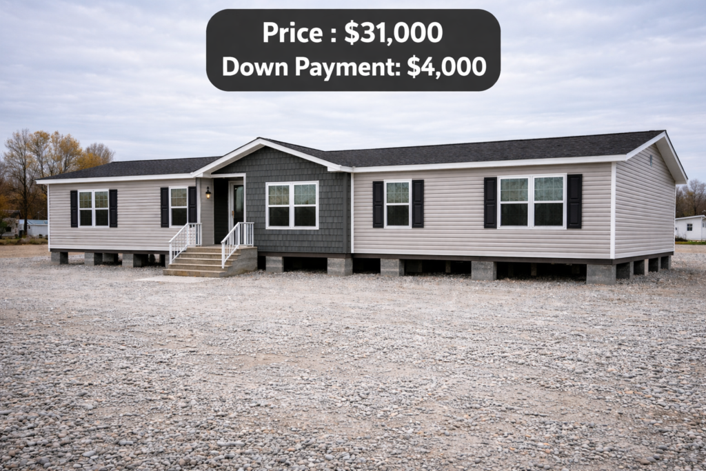 Single-story beige manufactured home with black shutters on a gravel lot, overcast sky. Text overlay: "Price: $31,000, Down Payment: $4,000."